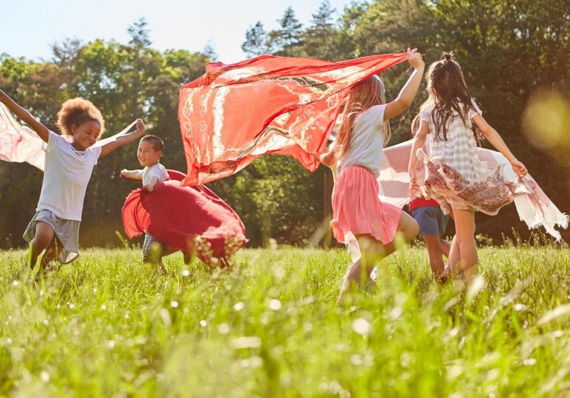 Group-of-kids-running-and-dancing-with-towels-min-scaled